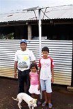 A Masaya family with their solar panel